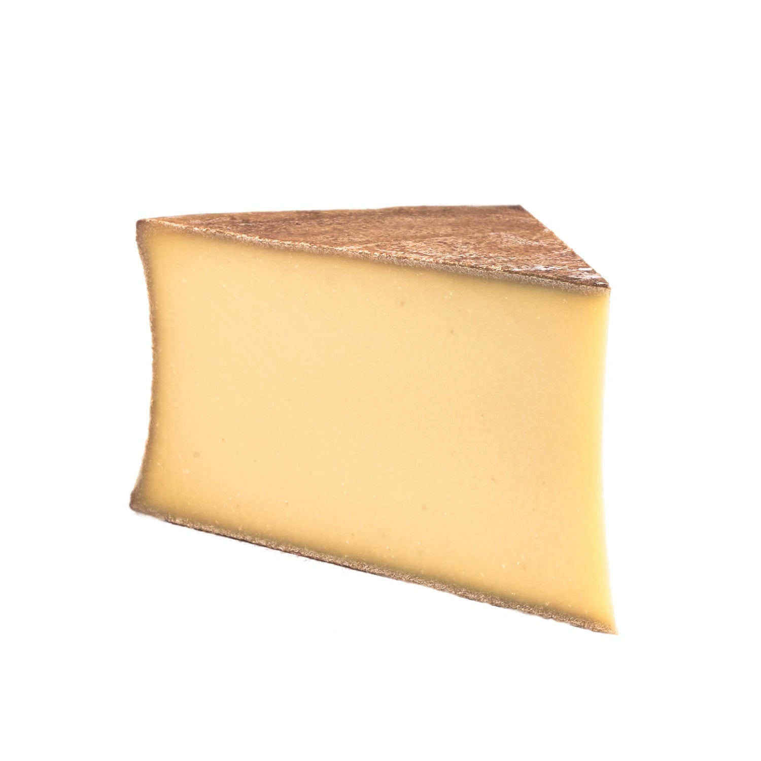 A wedge of Beaufort cheese with its pale yellow color and smooth texture, surrounded by rustic bread and grapes, showcasing its traditional French Alpine origins and artisanal craftsmanship.