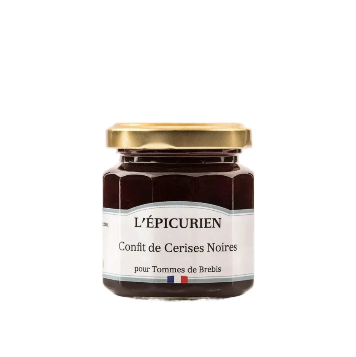 Jar of artisanal black cherry jam from the Basque Country, showing a fruit-rich texture through the glass.