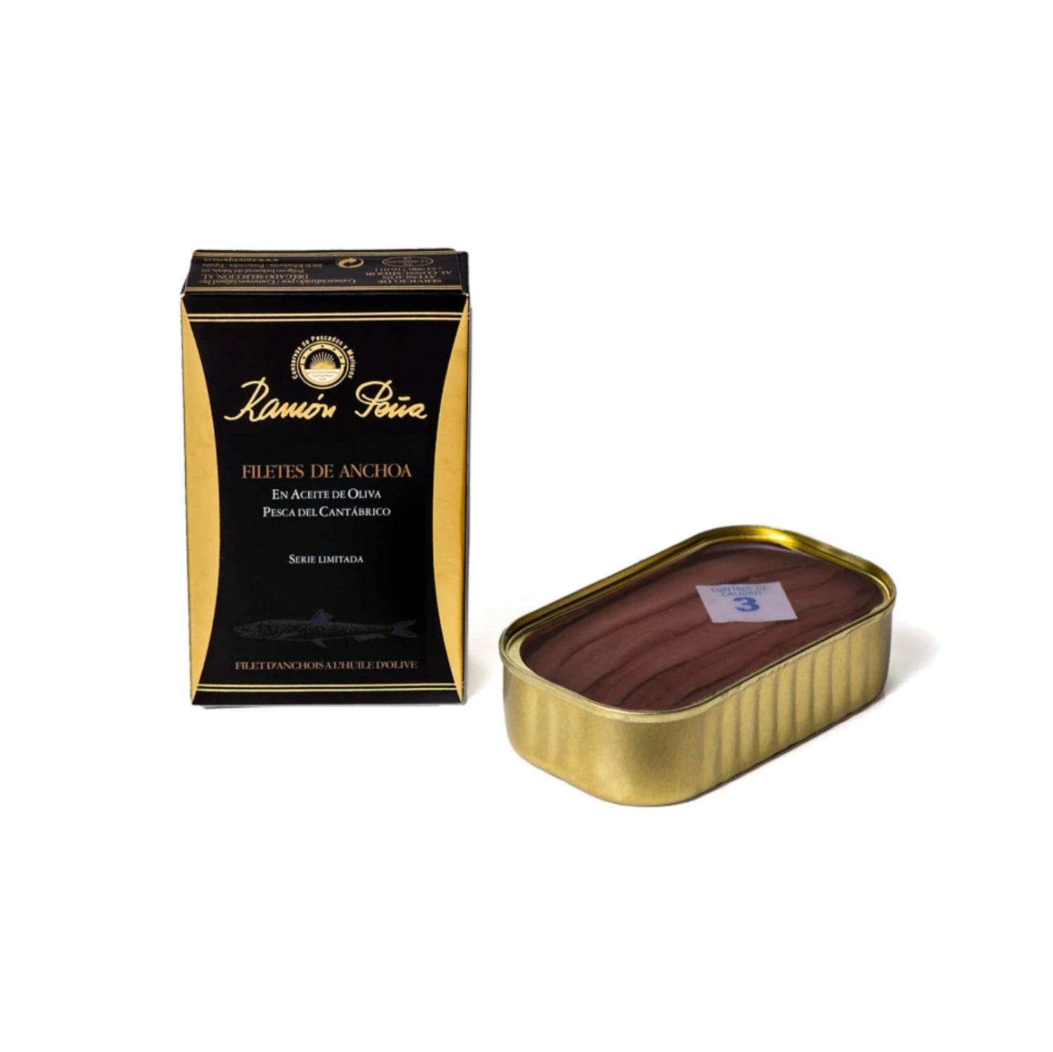 Ramon Peña's Black Label Anchovy Fillets in elegant tin. Served as tapas on rustic bread, alongside a small bowl of anchovy-based sauce. Mediterranean herbs and lemon garnish.