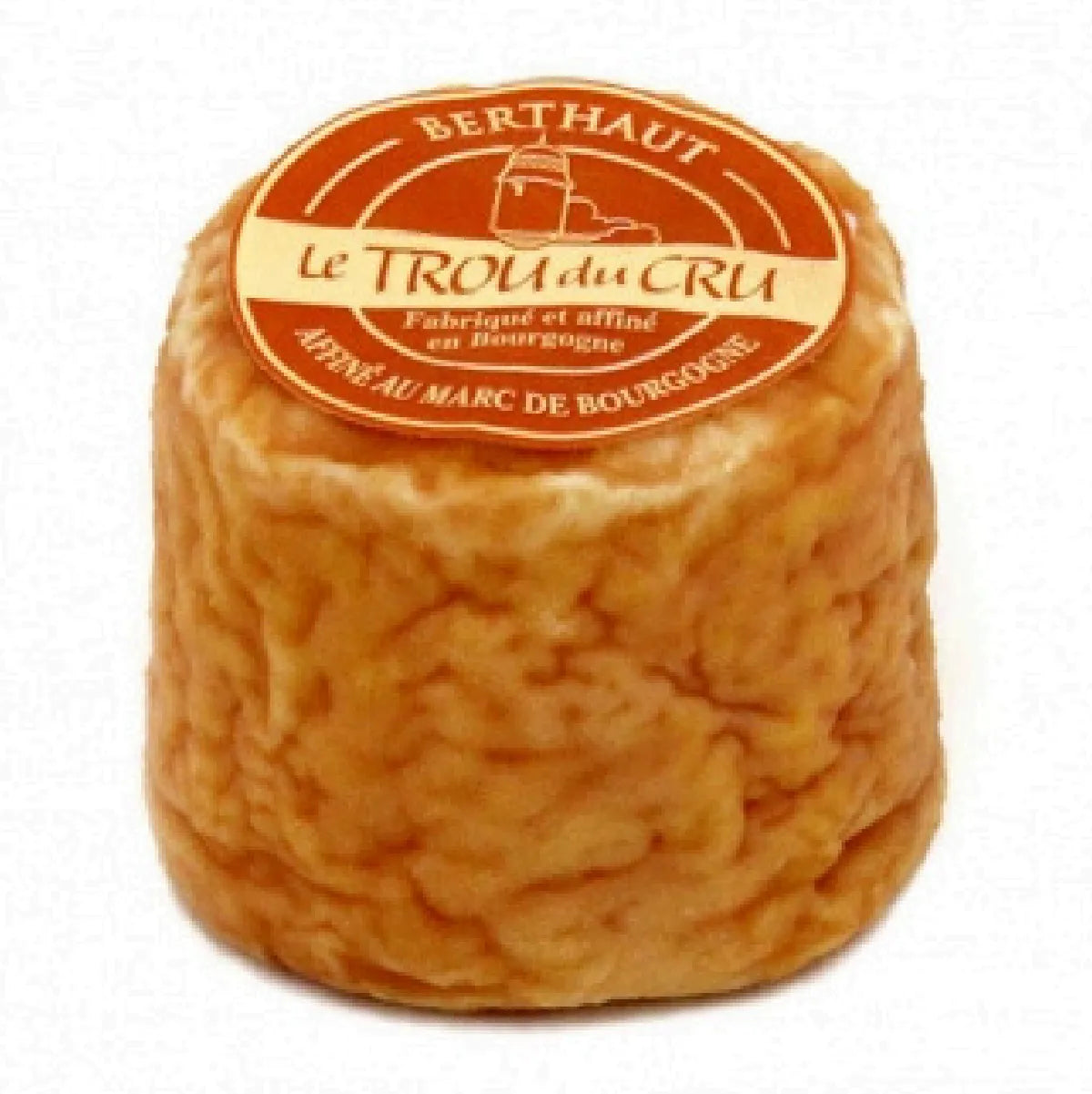 Le Trou du Cru cheese: the world's smallest washed rind cheese, known for its creamy texture, powerful flavor, and vibrant orange-red color.