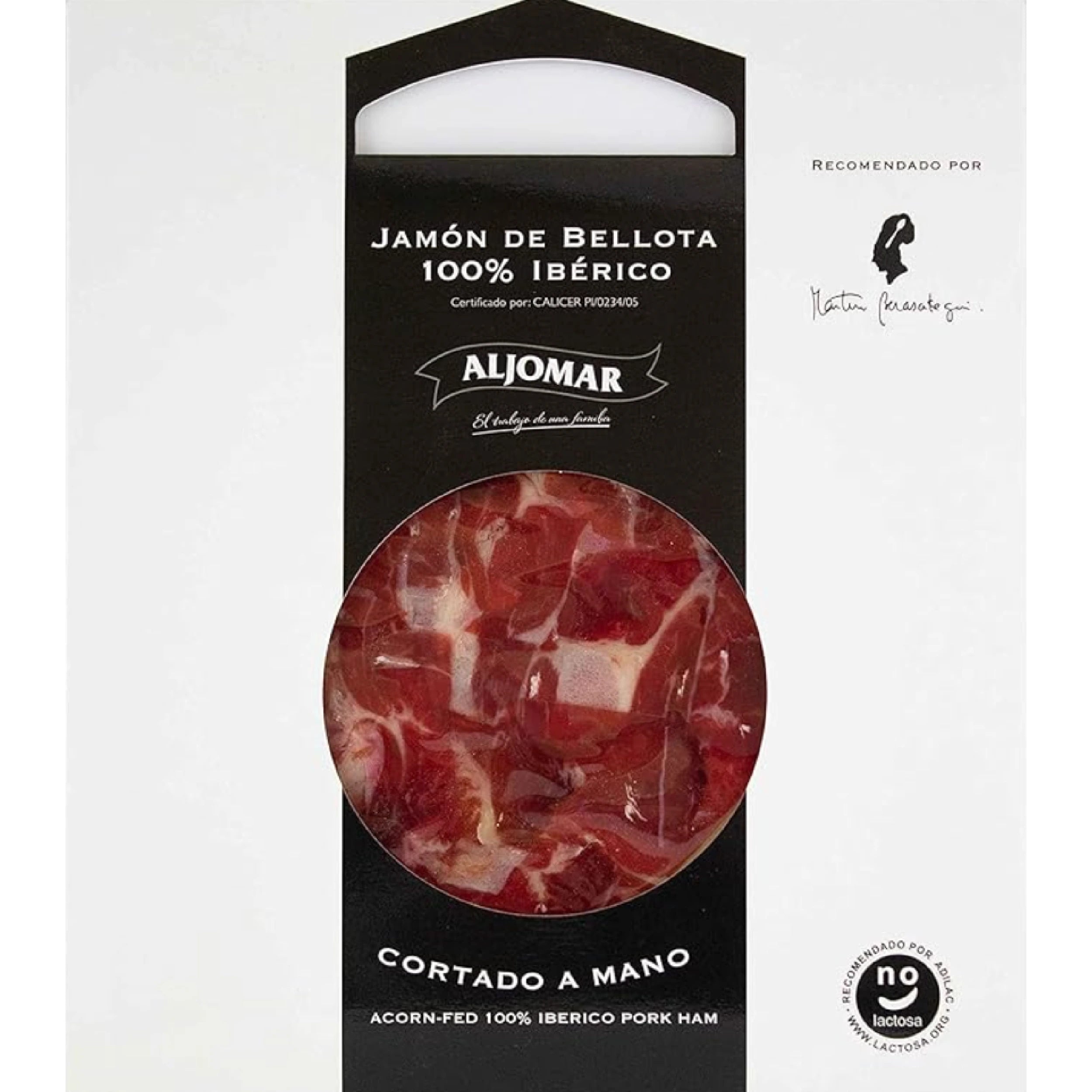 Elegant packaging of Aljomar's 100% Ibérico Bellota Ham. A large circular window reveals finely marbled ham slices with a characteristic deep red color. The Aljomar logo and "Cortado a mano" (hand-sliced) mention are clearly visible, along with a "no lactosa" (lactose-free) label and an expert recommendation, emphasizing the product's premium quality.