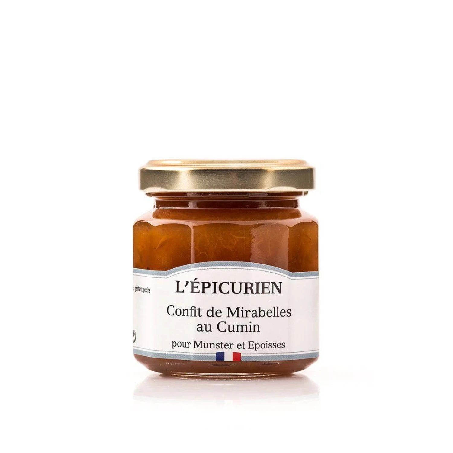 A jar of golden Mirabelle Plum and Cumin Confit, its contents glistening with visible plum pieces and cumin seeds. Surrounding the jar are fresh Mirabelle plums from Lorraine, France, and a small pile of aromatic cumin seeds.