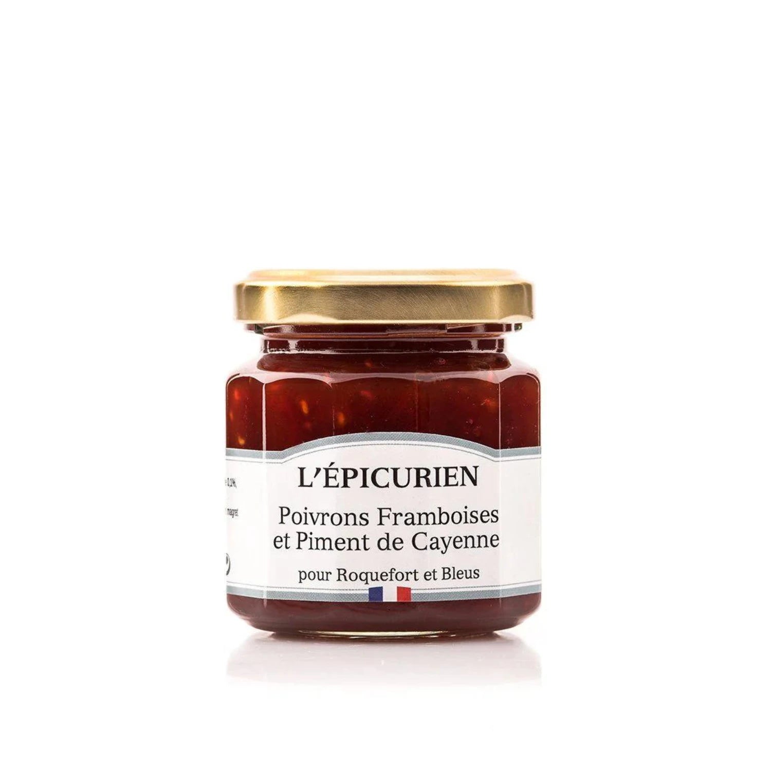 A jar of vibrant Raspberry and Pepper Confit, its rich red color flecked with visible pepper pieces. The jar is open, revealing the smooth, spreadable texture of the confit.