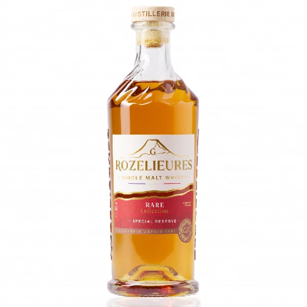 Bottle of Rozelieures Rare Collection whisky, red and gold label, golden amber liquid, wooden cap.
