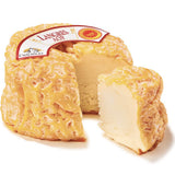 Langres AOP cheese with its signature sunken top, creamy orange rind, and rich, washed-rind texture — a traditional French cow’s milk cheese from Champagne.