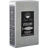 Ramon Peña's Yellowfin Tuna in olive oil tin, open to reveal succulent tuna chunks. Served on toasted bread and in a colorful Mediterranean salad, showcasing its versatility.