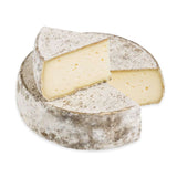Wheel of Tomme de Savoie cheese with a rustic rind, showcasing its firm texture. Displayed on a wooden board alongside crusty bread and a glass of Savoyard wine, highlighting its versatility in Alpine cuisine
