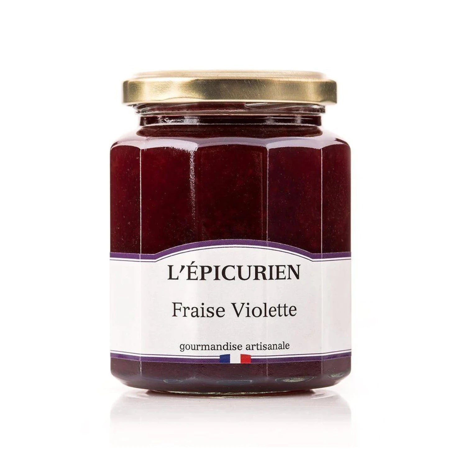 Jar of artisanal Strawberry and Violet Jam with visible fruit pieces. Vibrant red spread on rustic bread, surrounded by fresh strawberries, violet flowers, and a gourmet cheese assortment.