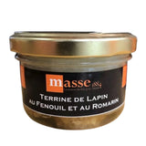 Glass jar of Rabbit Terrine with Fennel and Rosemary from the Masse brand, featuring a golden lid and a black and orange label.