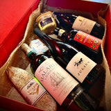 Roman gift hamper featuring fine wines, gourmet olive oil, premium salami, and whole goose foie gras from Baron Max Wines.