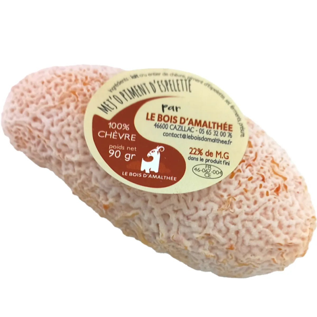 Soft artisanal cheese Mej o Piment, coated with ash and flecks of red chili, showing a creamy white interior and rustic rind.