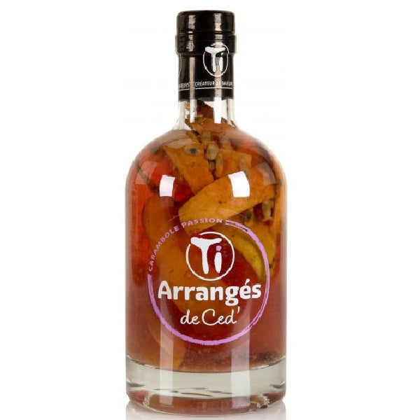 Bottle of Ti Ced Carambola Passion Arranged Rum, containing pieces of carambola and passion fruit, with a black and purple label.