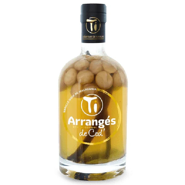 Bottle of Ti Ced Vanilla Macadamia Nut Arranged Rum, containing whole macadamia nuts and vanilla beans, with a black and gold label.