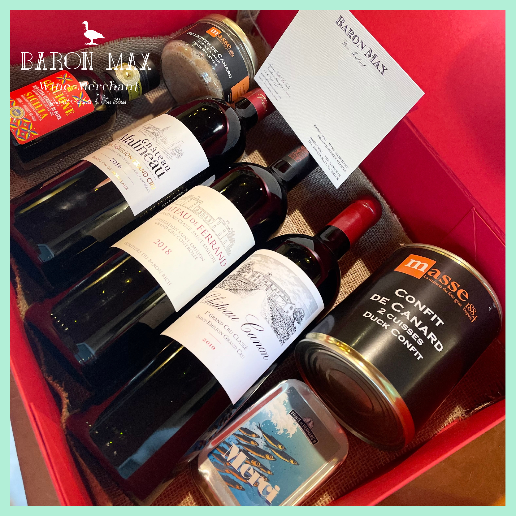 The Jurade Gift Hamper featuring Saint-Émilion Grand Crus, gourmet French delicacies, and premium olive oil in an elegant gift box.