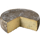 Tomme à l’ail des ours from Laiterie Vichy, cow’s milk cheese infused with wild garlic, semi-firm texture and fresh herbal flavor.