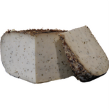 Goat’s milk tomme with thyme and honey, featuring a semi-firm texture and a delicate balance of floral sweetness and aromatic herbs.