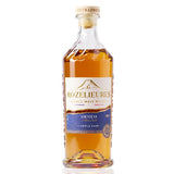 Bottle of Rozelieures Origine Collection whisky, with a white and blue label, containing a golden amber liquid