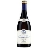 A bottle of 2019 Les Chausmes from Domaine Cassagne et Vitailles, showcasing a deep garnet color with intense red highlights. This wine from the Montpeyroux region is crafted from a proprietary blend and aged to reveal rich and complex aromas. It features a rich and complex bouquet with notes of ripe red fruits, chocolate, sweet spices, and white pepper. The palate is opulent and well-structured, offering concentrated berry flavors, hints of licorice, and a persistent freshness