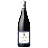 A sleek, slender bottle stands proudly, its elongated neck tapering gracefully towards a rounded base. This unique vessel, adorned with an elegant label, contains the essence of Cornas: a 100% Syrah cuvée sourced from the renowned vineyards of "Les Côtes," "Reynard," and "Cayret."